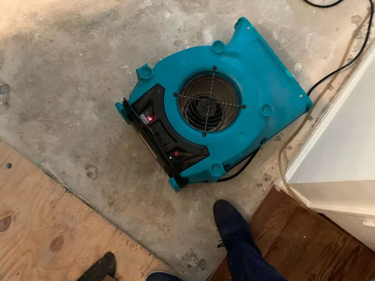 Air mover drying subfloor during Commercial Water Damage Restoration in Norton Shores